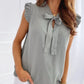 Sleeveless Blouse with Ruffles and Bow Detail